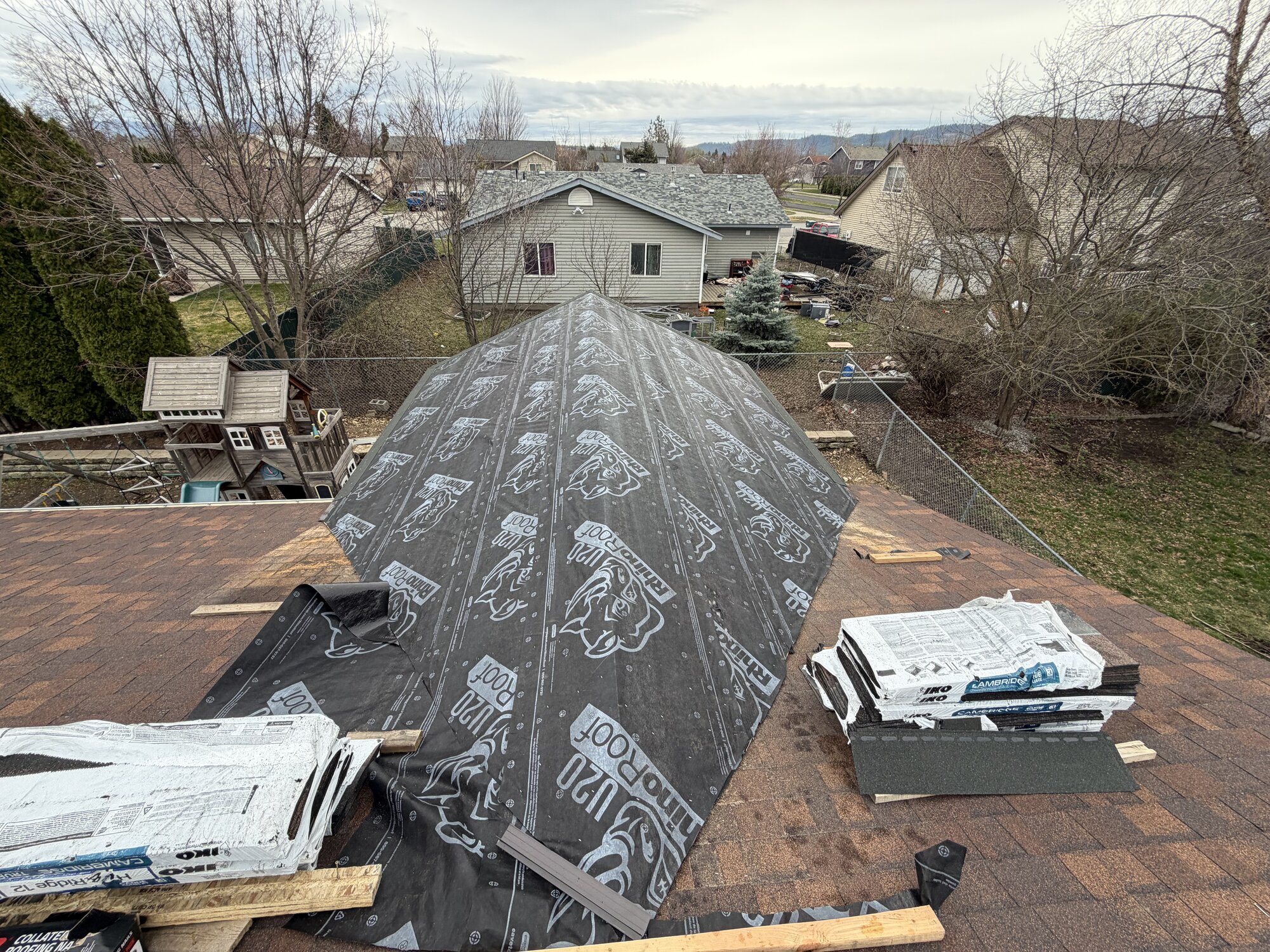 Roofing Rehab jobsite with underlayment and materials staged